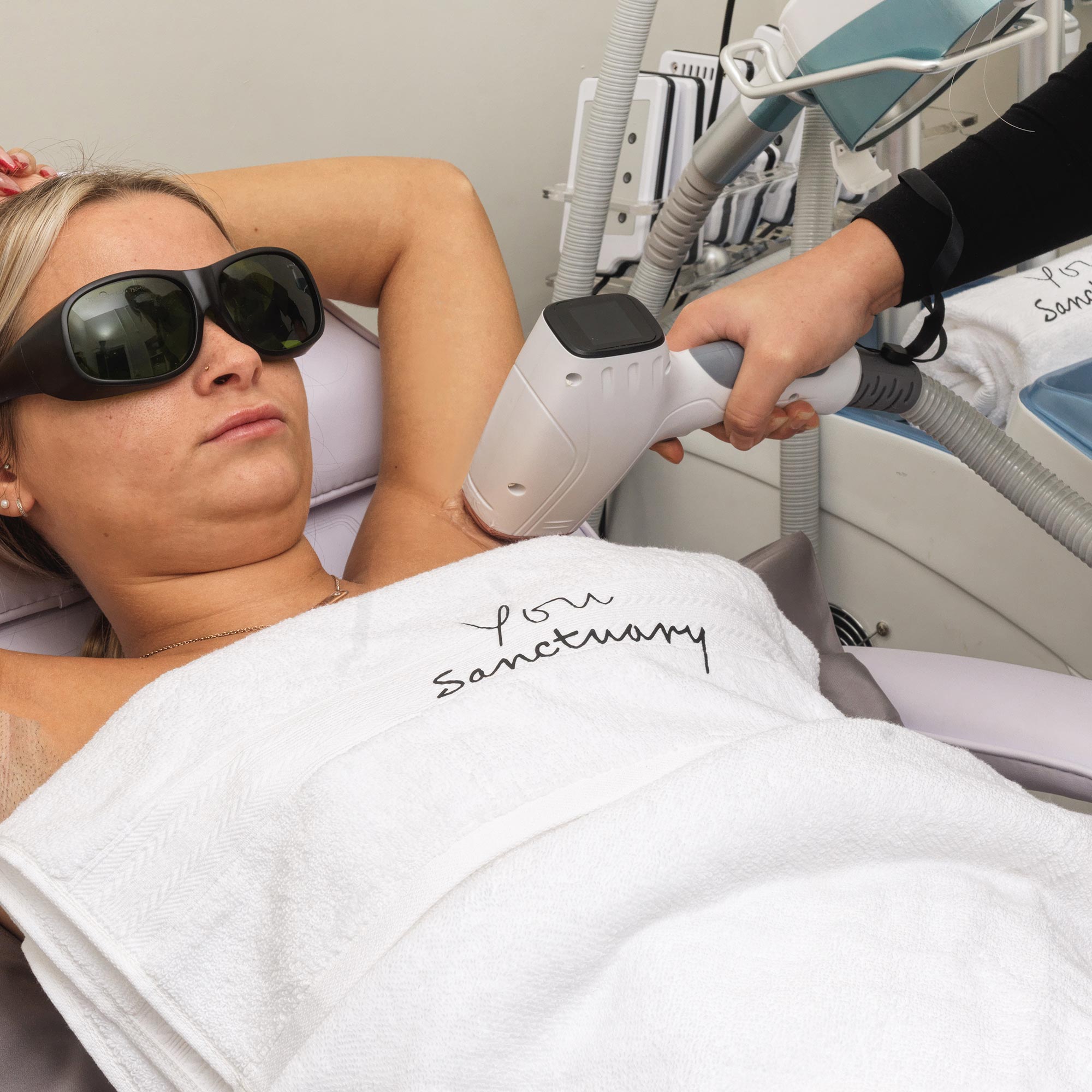 Woman getting laser hair removal on her armpits